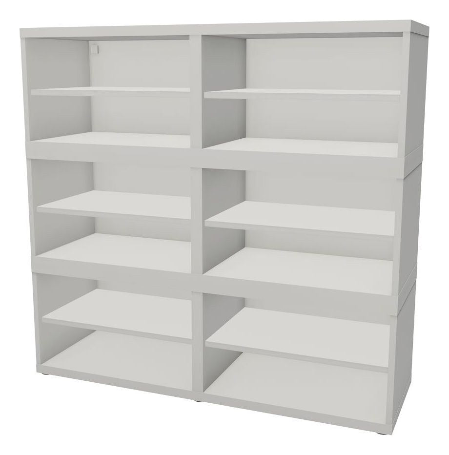 Three white IKEA BESTÅ frames stacked into an open shelving unit with six shelves